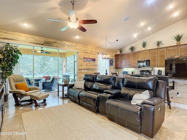 645 Elk River Dr, Ormond Beach, FL 32174 - living area featuring light tile patterned floors, visible vents, high vaulted ceiling, ceiling fan, and wood walls