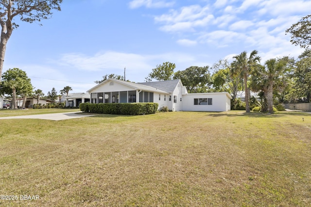 view of front of house featuring concrete driveway and a front yard