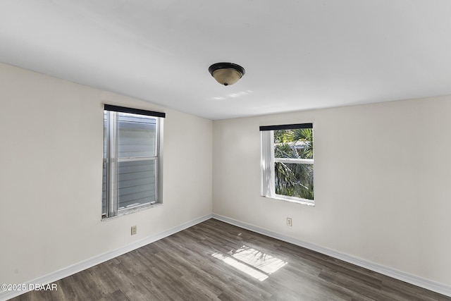 unfurnished room with wood finished floors and baseboards