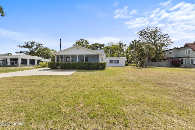 bungalow-style house with a front yard and a sunroom