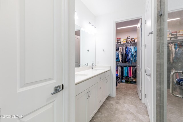 613 Good Life Way, Daytona Beach, FL 32124 - bathroom featuring double vanity, a stall shower, a walk in closet, and tile patterned floors