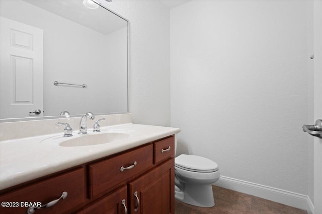 bathroom featuring tile patterned flooring, vanity, and toilet