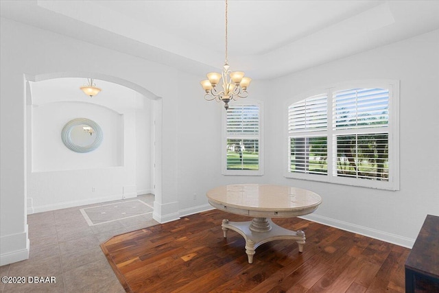 dining space with wood-type flooring and a chandelier