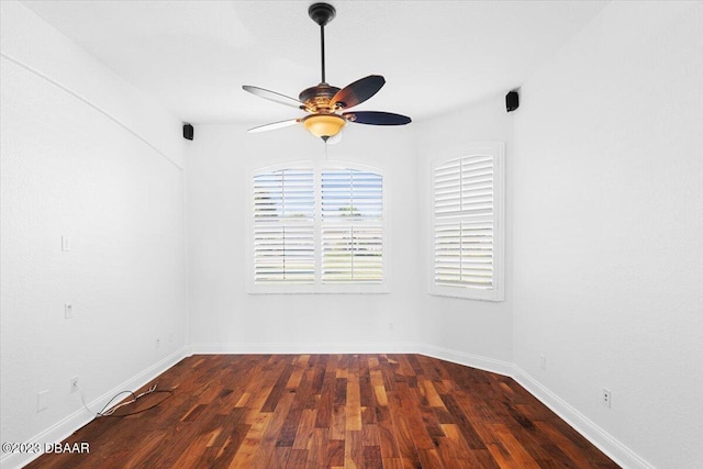 empty room featuring ceiling fan and dark hardwood / wood-style floors