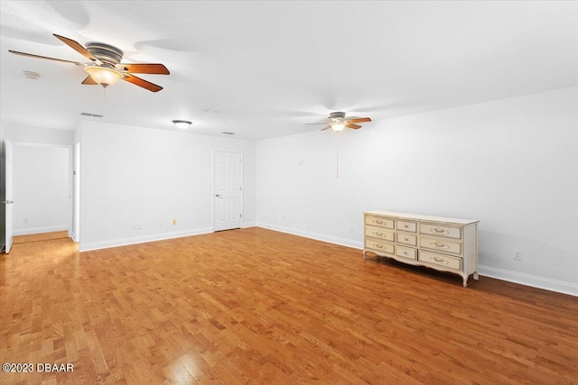 unfurnished room with hardwood / wood-style floors and ceiling fan