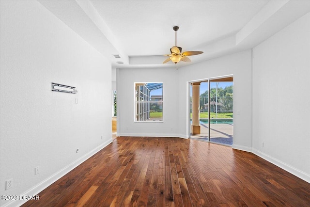 empty room with ceiling fan and dark hardwood / wood-style floors