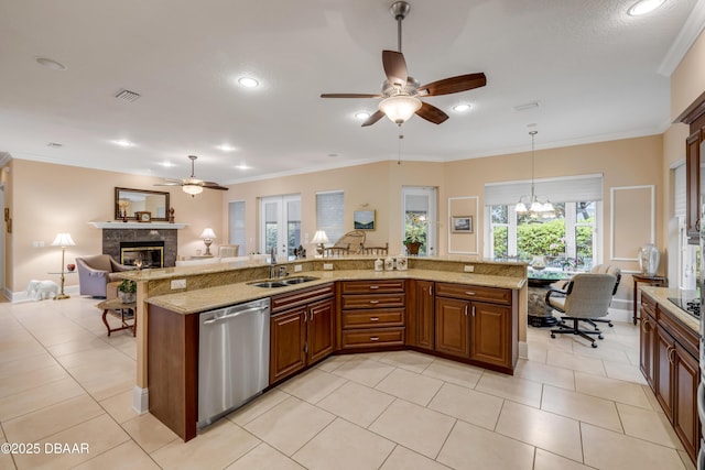 kitchen with visible vents, open floor plan, a sink, a tile fireplace, and dishwasher