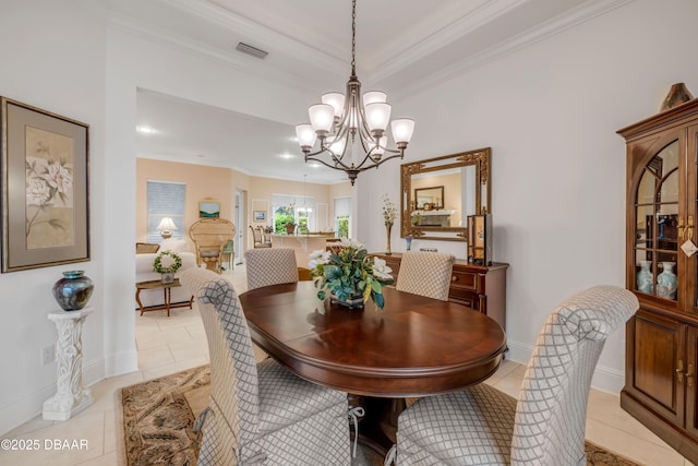 dining area with light tile patterned flooring, a notable chandelier, visible vents, baseboards, and crown molding