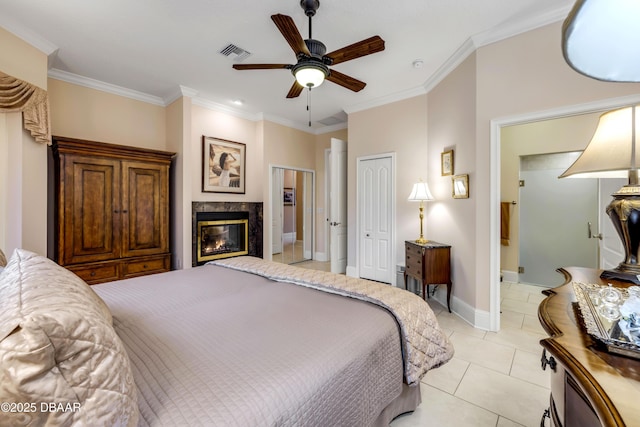 bedroom featuring light tile patterned floors, ornamental molding, a premium fireplace, and visible vents