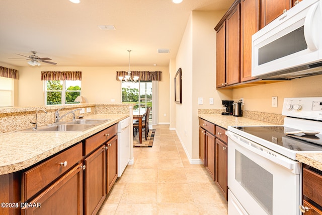 kitchen with ceiling fan with notable chandelier, sink, light tile patterned floors, pendant lighting, and white appliances