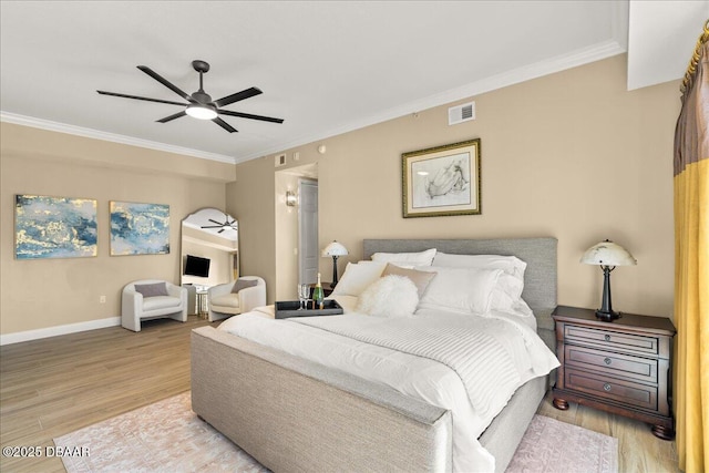 bedroom featuring light hardwood / wood-style flooring, ceiling fan, and ornamental molding