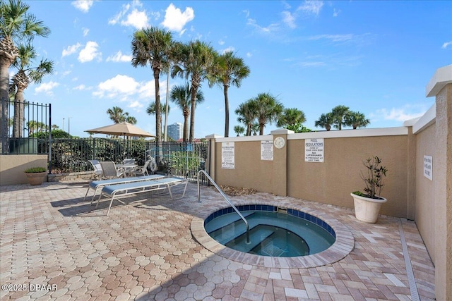 view of swimming pool with a patio and a hot tub