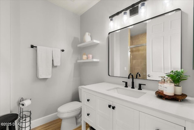 bathroom featuring a shower with door, vanity, hardwood / wood-style floors, and toilet