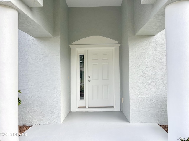 property entrance featuring stucco siding