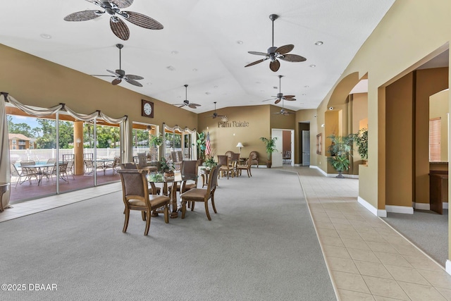 4600 E Moody Blvd Unit 14-O, Bunnell, FL 32110 - dining space with light tile patterned flooring, a ceiling fan, high vaulted ceiling, light carpet, and arched walkways