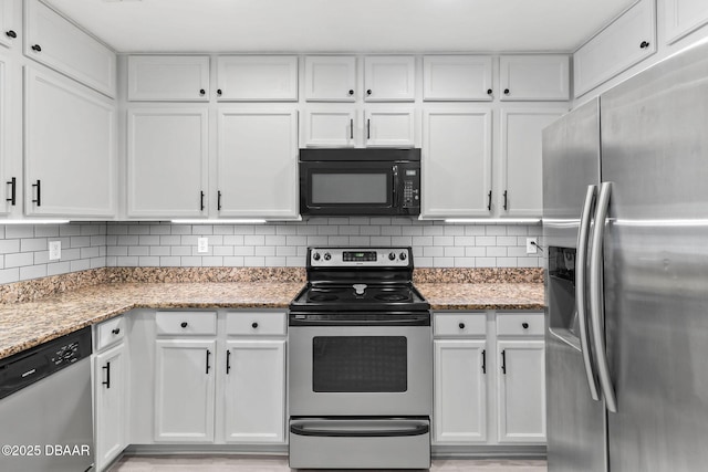 4600 E Moody Blvd Unit 14-O, Bunnell, FL 32110 - kitchen with stainless steel appliances, white cabinetry, decorative backsplash, and light stone countertops