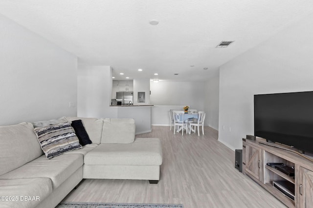 4600 E Moody Blvd Unit 14-O, Bunnell, FL 32110 - living room featuring light wood-style flooring and recessed lighting