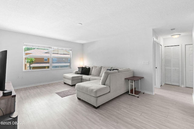 4600 E Moody Blvd Unit 14-O, Bunnell, FL 32110 - living room with light wood-style flooring and a textured ceiling