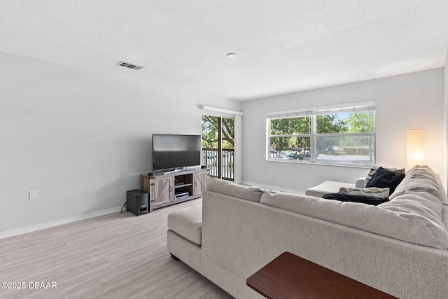 4600 E Moody Blvd Unit 14-O, Bunnell, FL 32110 - living area with light wood-type flooring and a textured ceiling
