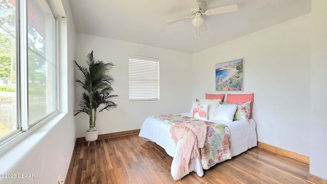 119 Rogers Park Dr, Ormond Beach, FL 32174 - bedroom featuring multiple windows, wood finished floors, and baseboards