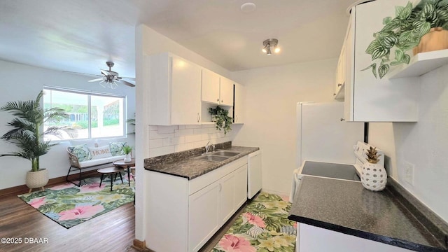 119 Rogers Park Dr, Ormond Beach, FL 32174 - kitchen with a sink, white appliances, dark countertops, tasteful backsplash, and a ceiling fan