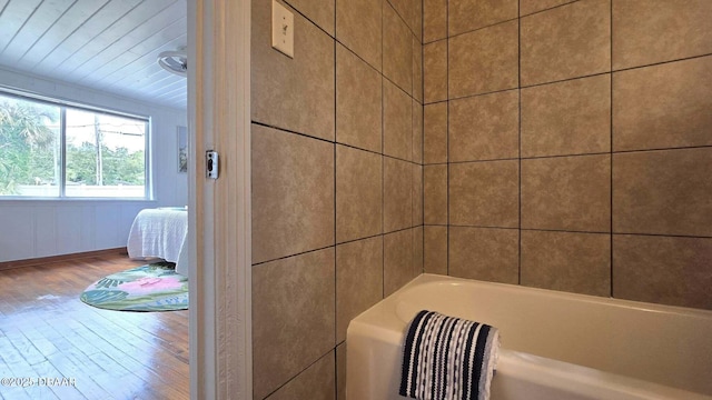 119 Rogers Park Dr, Ormond Beach, FL 32174 - ensuite bathroom featuring wood finished floors, a bathtub, and wooden ceiling