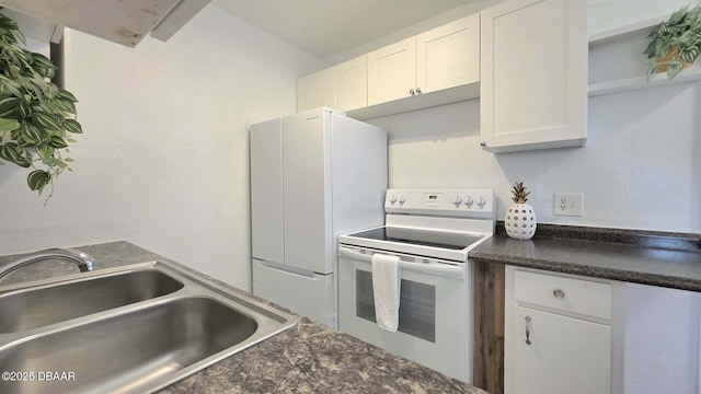 119 Rogers Park Dr, Ormond Beach, FL 32174 - kitchen with white range with electric cooktop, a sink, dark countertops, and white cabinets