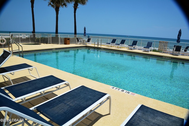 3145 S Atlantic Ave Unit 401, Daytona Beach, FL 32118 - view of swimming pool with a patio area and a water view