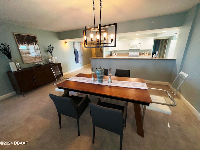 3145 S Atlantic Ave Unit 401, Daytona Beach, FL 32118 - dining area with light colored carpet and a notable chandelier