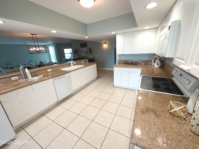 3145 S Atlantic Ave Unit 401, Daytona Beach, FL 32118 - kitchen with white cabinetry, pendant lighting, sink, and white appliances