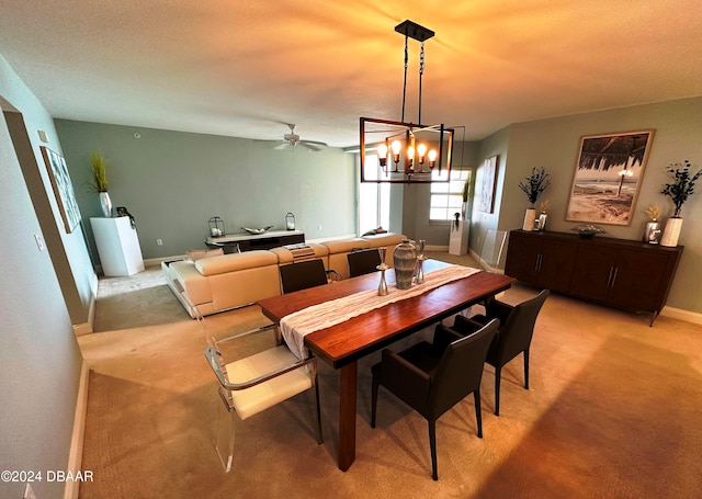 3145 S Atlantic Ave Unit 401, Daytona Beach, FL 32118 - dining space featuring ceiling fan with notable chandelier, light colored carpet, and a textured ceiling