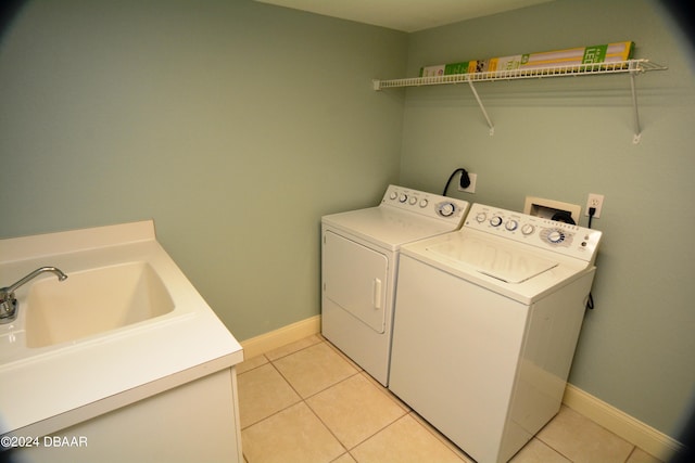 3145 S Atlantic Ave Unit 401, Daytona Beach, FL 32118 - clothes washing area with sink, light tile patterned floors, and washer and clothes dryer