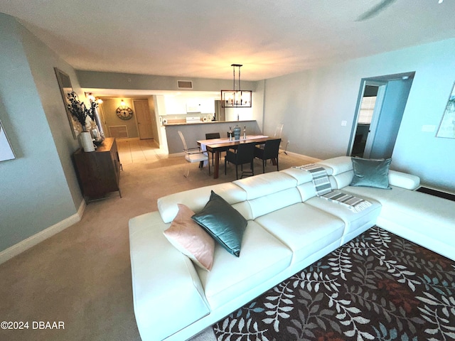 3145 S Atlantic Ave Unit 401, Daytona Beach, FL 32118 - living room with light carpet and a notable chandelier