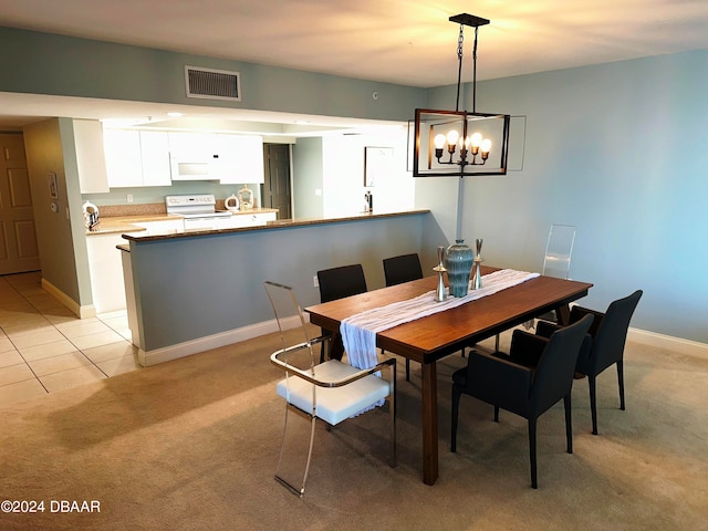 3145 S Atlantic Ave Unit 401, Daytona Beach, FL 32118 - dining room featuring light colored carpet and a notable chandelier