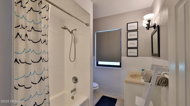 103 Cone Rd, Ormond Beach, FL 32174 - bathroom with toilet, vanity, shower / bathtub combination with curtain, tile walls, and tile patterned floors