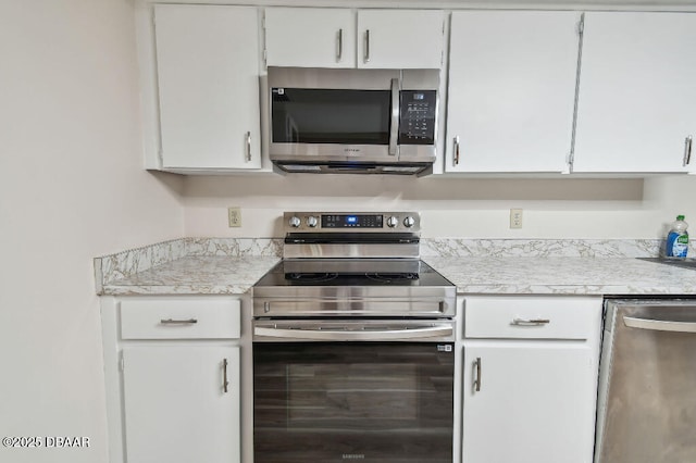 2421 Needle Palm Dr, Edgewater, FL 32141 - kitchen featuring stainless steel appliances, light countertops, and white cabinetry