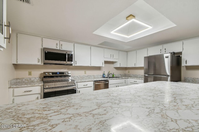 2421 Needle Palm Dr, Edgewater, FL 32141 - kitchen with appliances with stainless steel finishes, a sink, white cabinetry, and light stone counters