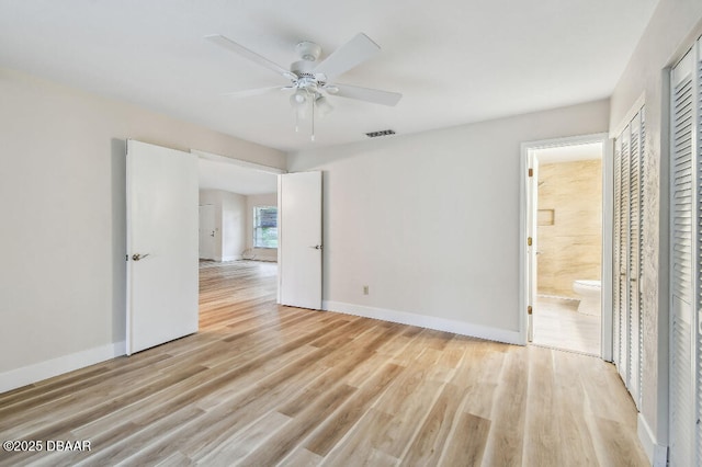 2421 Needle Palm Dr, Edgewater, FL 32141 - unfurnished bedroom featuring light wood-style flooring, baseboards, and connected bathroom