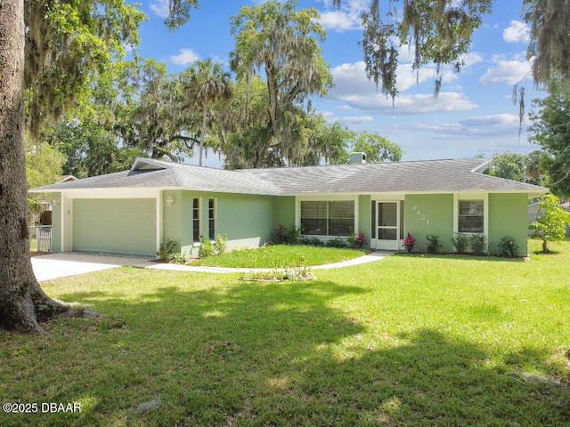 2421 Needle Palm Dr, Edgewater, FL 32141 - single story home featuring stucco siding, a garage, a front yard, and concrete driveway