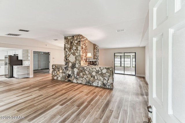 2421 Needle Palm Dr, Edgewater, FL 32141 - unfurnished living room featuring lofted ceiling and light wood-style floors