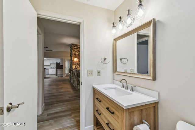 2421 Needle Palm Dr, Edgewater, FL 32141 - half bath with wood finished floors, vanity, and toilet