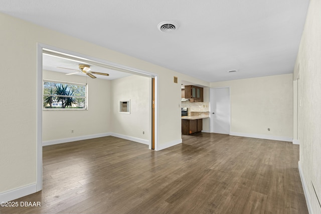 unfurnished living room featuring dark hardwood / wood-style floors and ceiling fan