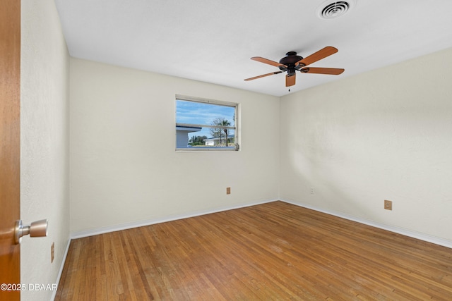 spare room with hardwood / wood-style flooring and ceiling fan