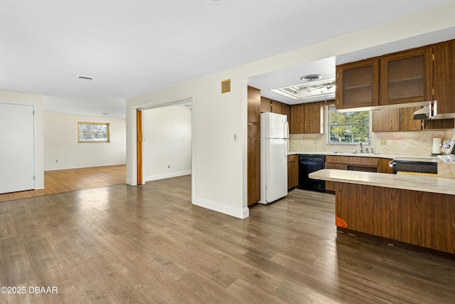 kitchen featuring dishwasher, sink, stainless steel range with electric stovetop, white refrigerator, and dark wood-type flooring