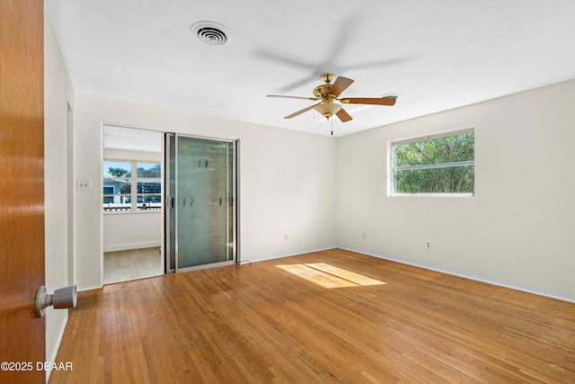 empty room featuring hardwood / wood-style floors and ceiling fan