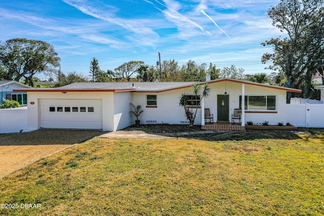 ranch-style house featuring a garage and a front lawn