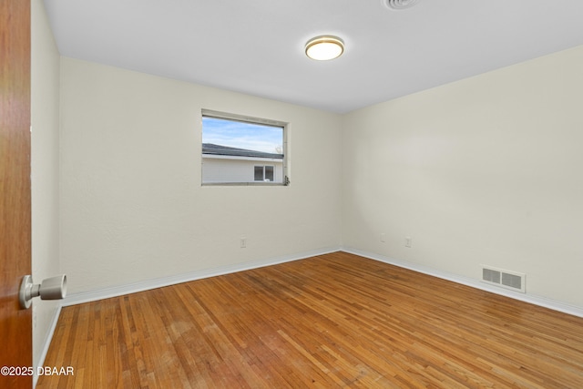 empty room featuring hardwood / wood-style flooring