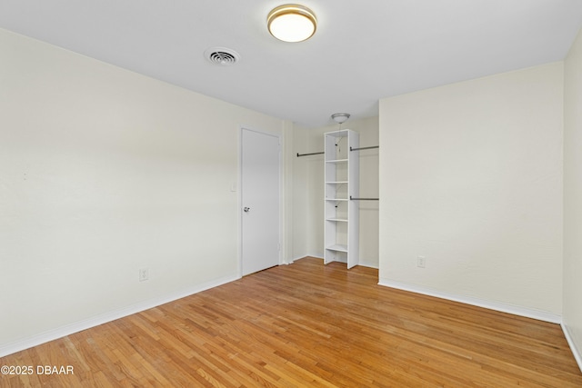 spare room featuring light hardwood / wood-style flooring