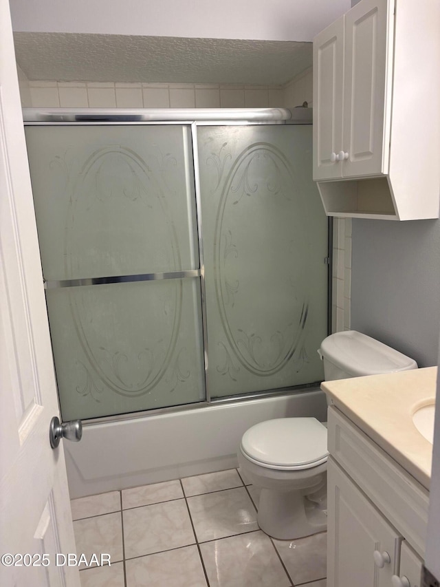 full bathroom with vanity, tile patterned flooring, bath / shower combo with glass door, and toilet