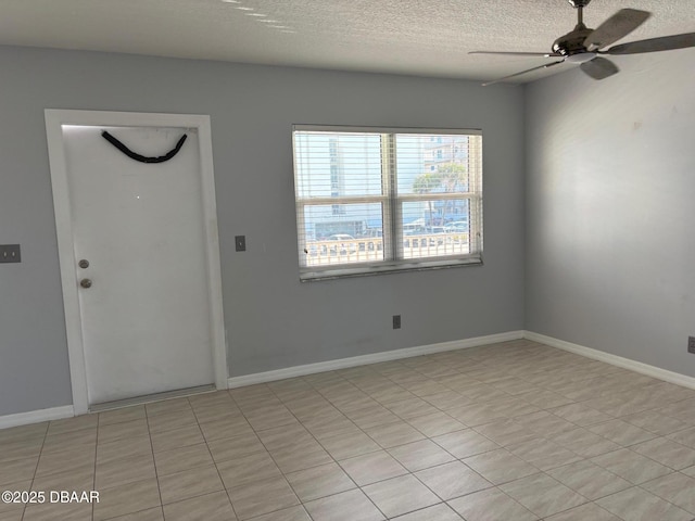 interior space with ceiling fan and a textured ceiling